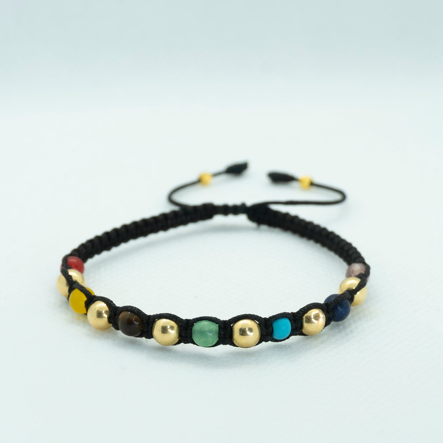 PULSERA TEJIDA CON PIEDRA COLORES